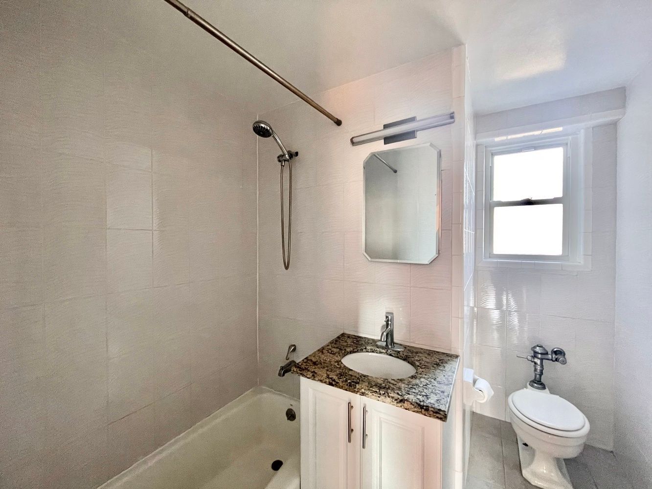 345 West 145th Street, Unit 8A1 Manhattan, NY 10031 - Photo 6 of 7 a bathroom with a granite countertop sink toilet and shower