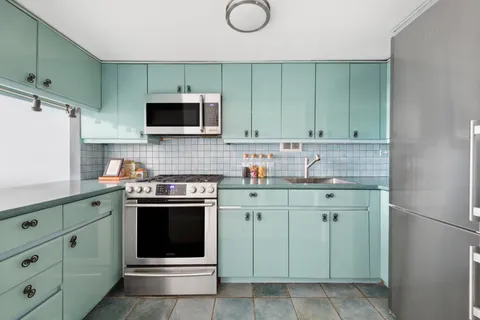 a kitchen with stainless steel appliances granite countertop a stove and a sink