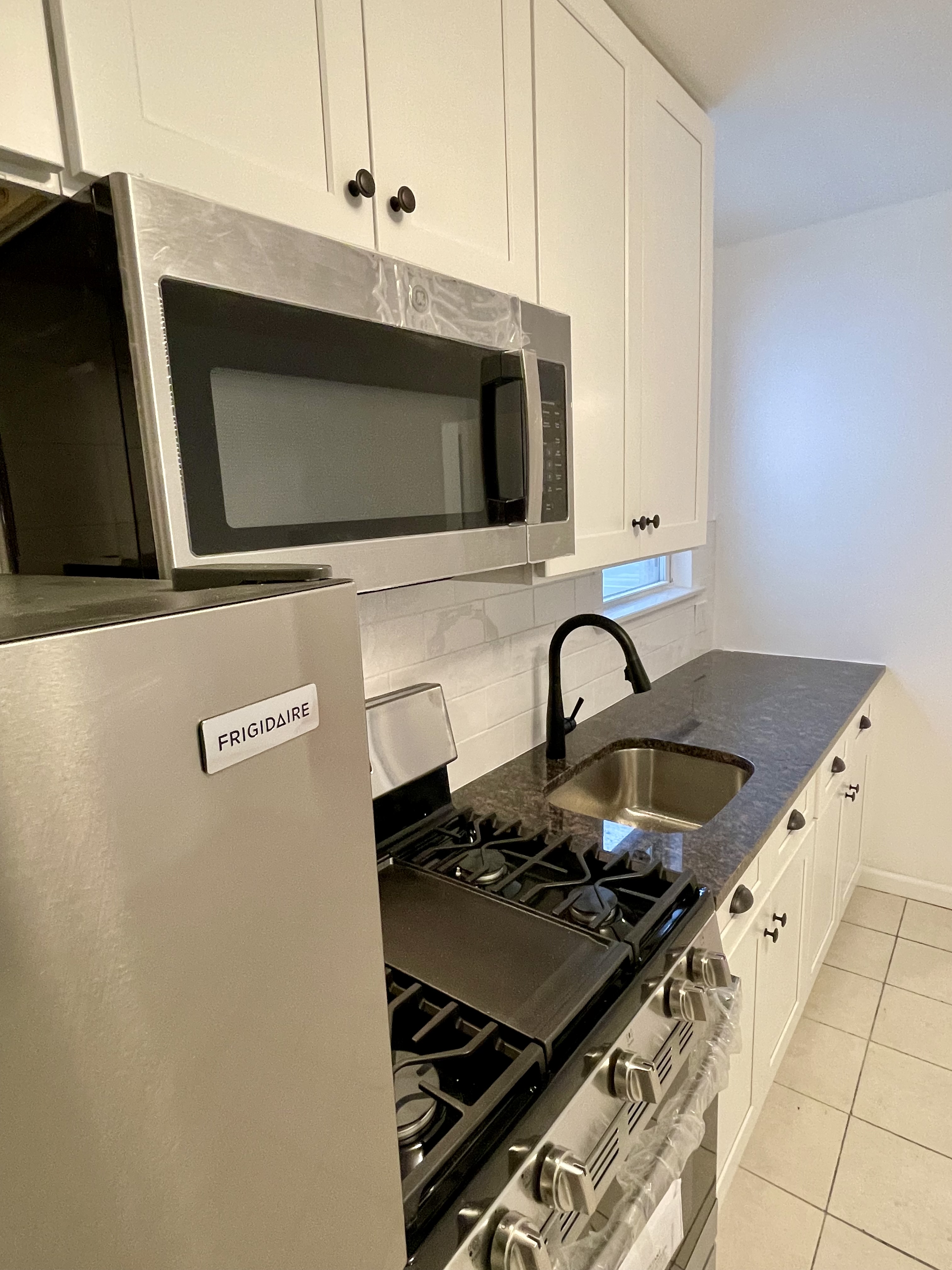 3194 Webster Avenue Bronx, NY 10467 - Photo 8 of 23 a kitchen with a stove and a microwave