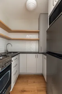 a kitchen with white cabinets and a stove top oven