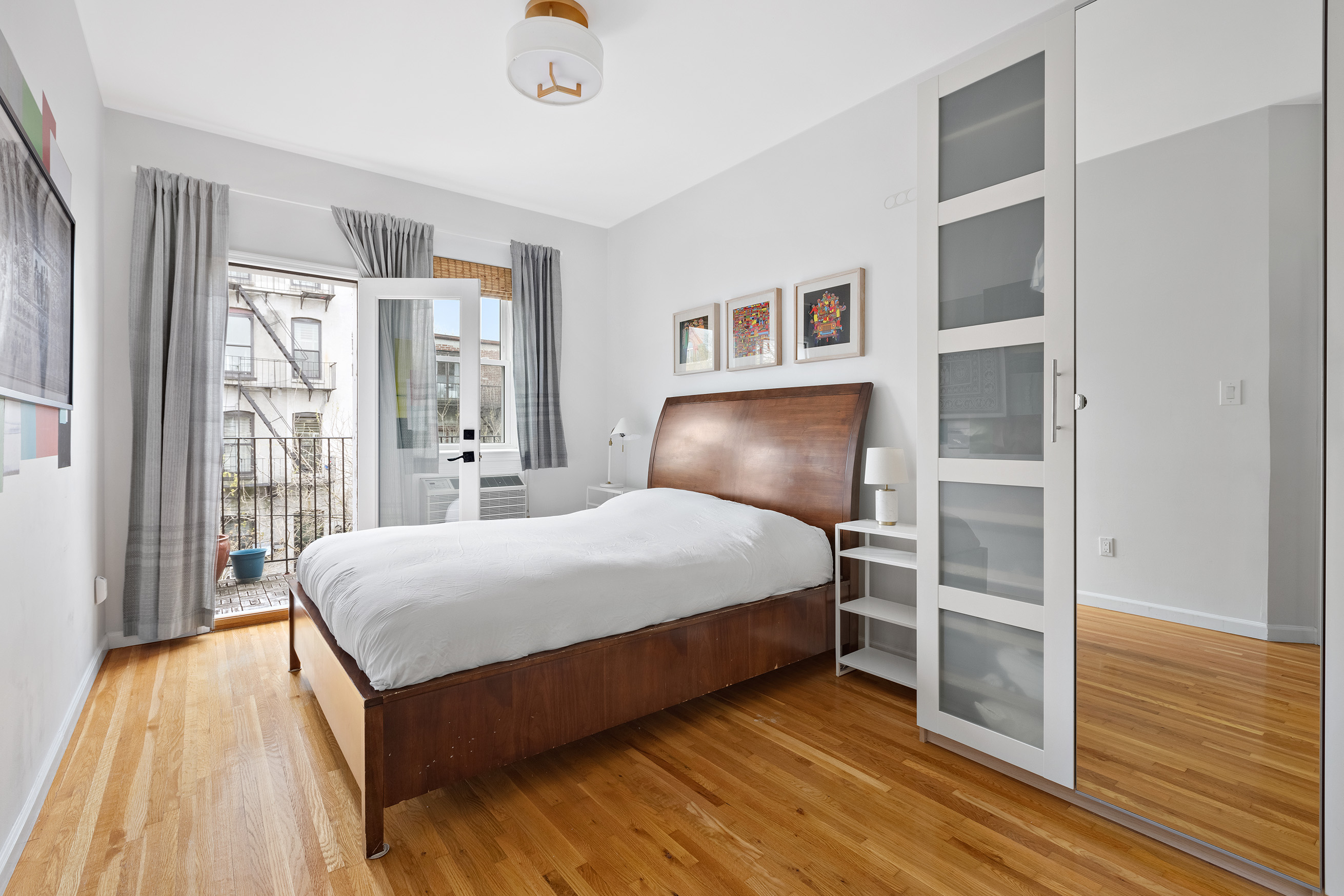 454 12th Street, Unit 3 Brooklyn, NY 11215 - Photo 7 of 18 a bedroom with a bed and a large window