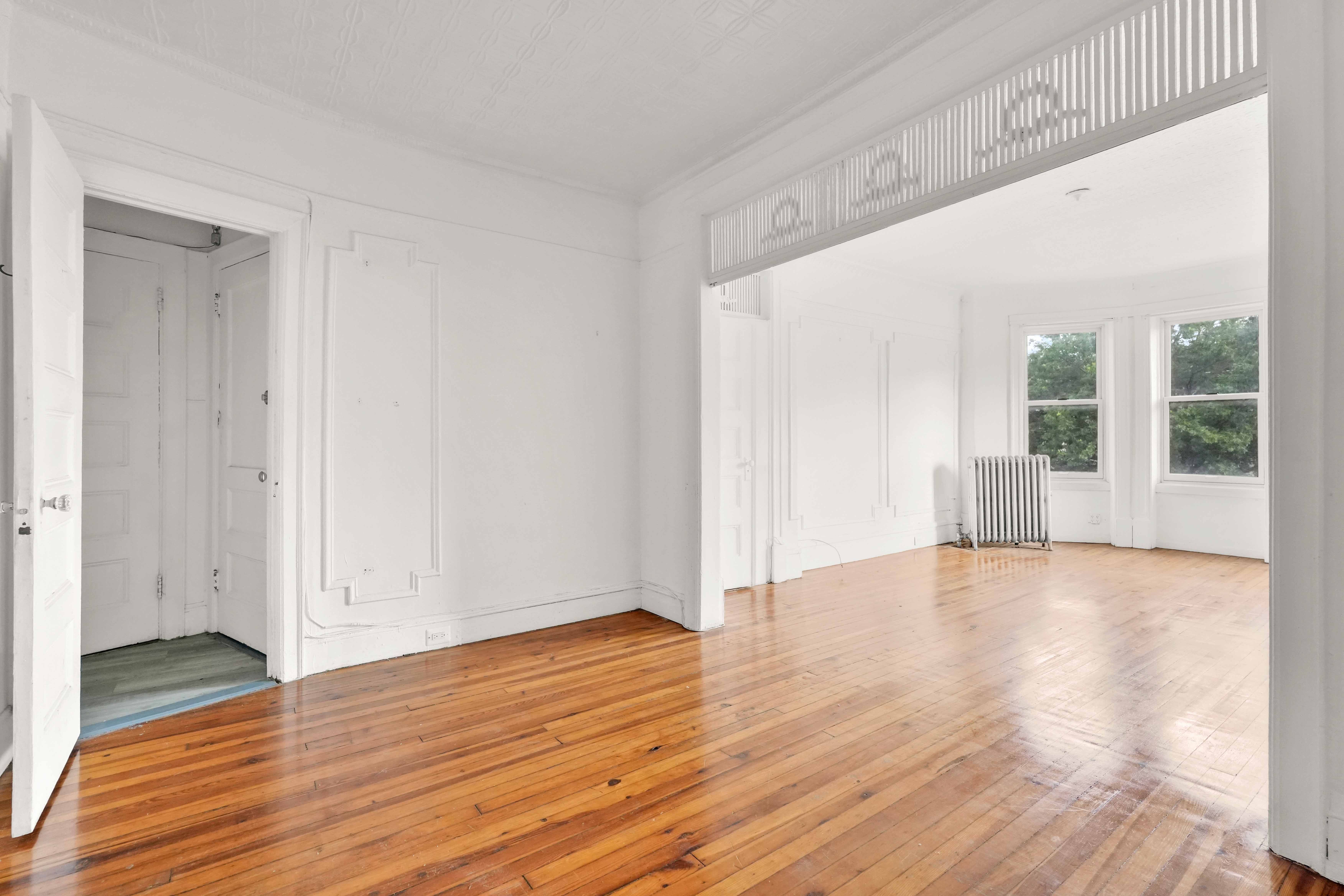 278 Lefferts Avenue Brooklyn, NY 11225 - Photo 8 of 56 a view of empty room with wooden floor and fan