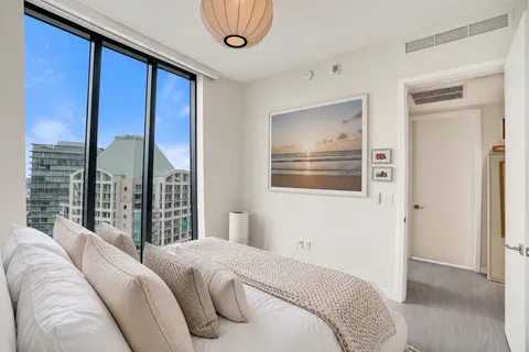 a bedroom with a large bed and a large window