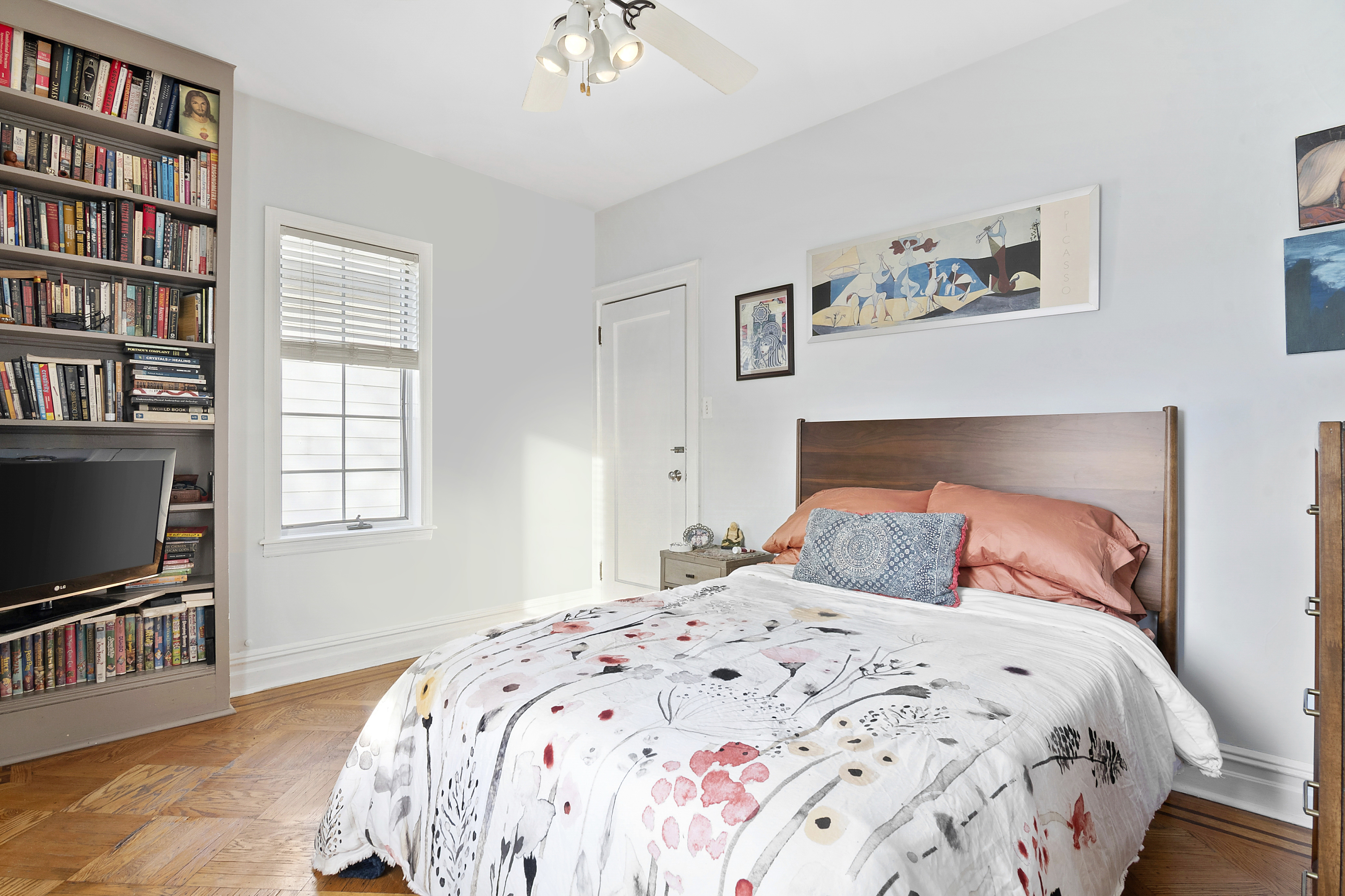 1384 East 29th Street Brooklyn, NY 11210 - Photo 7 of 21 a bedroom with a bed and a flat screen tv