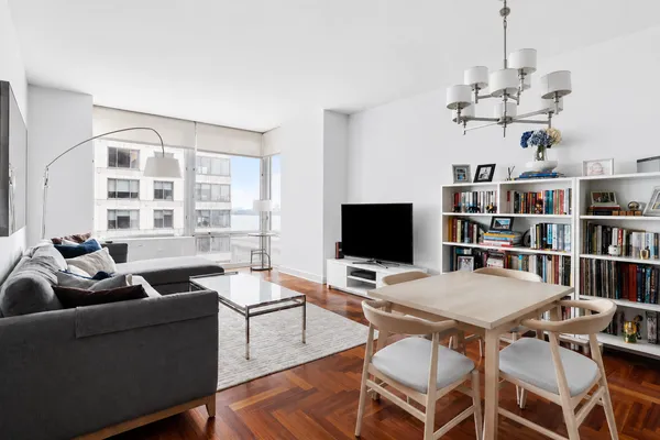 a view of a livingroom with furniture and a bookshelf