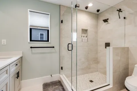 a bathroom with a shower and toilet