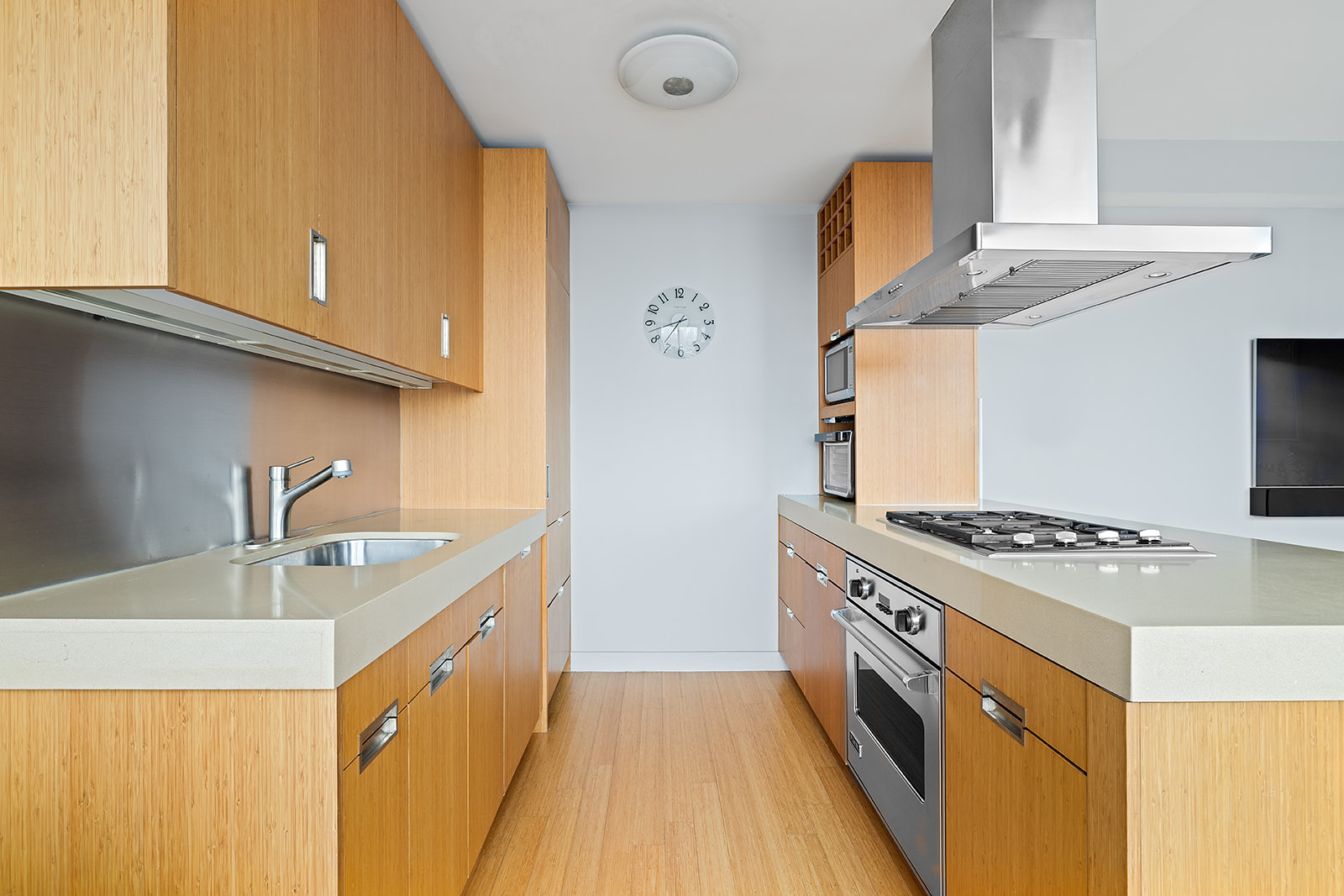 450 West 17th Street, Unit 2302 Manhattan, NY 10011 - Photo 3 of 6 a kitchen with stainless steel appliances granite countertop a sink stove and refrigerator