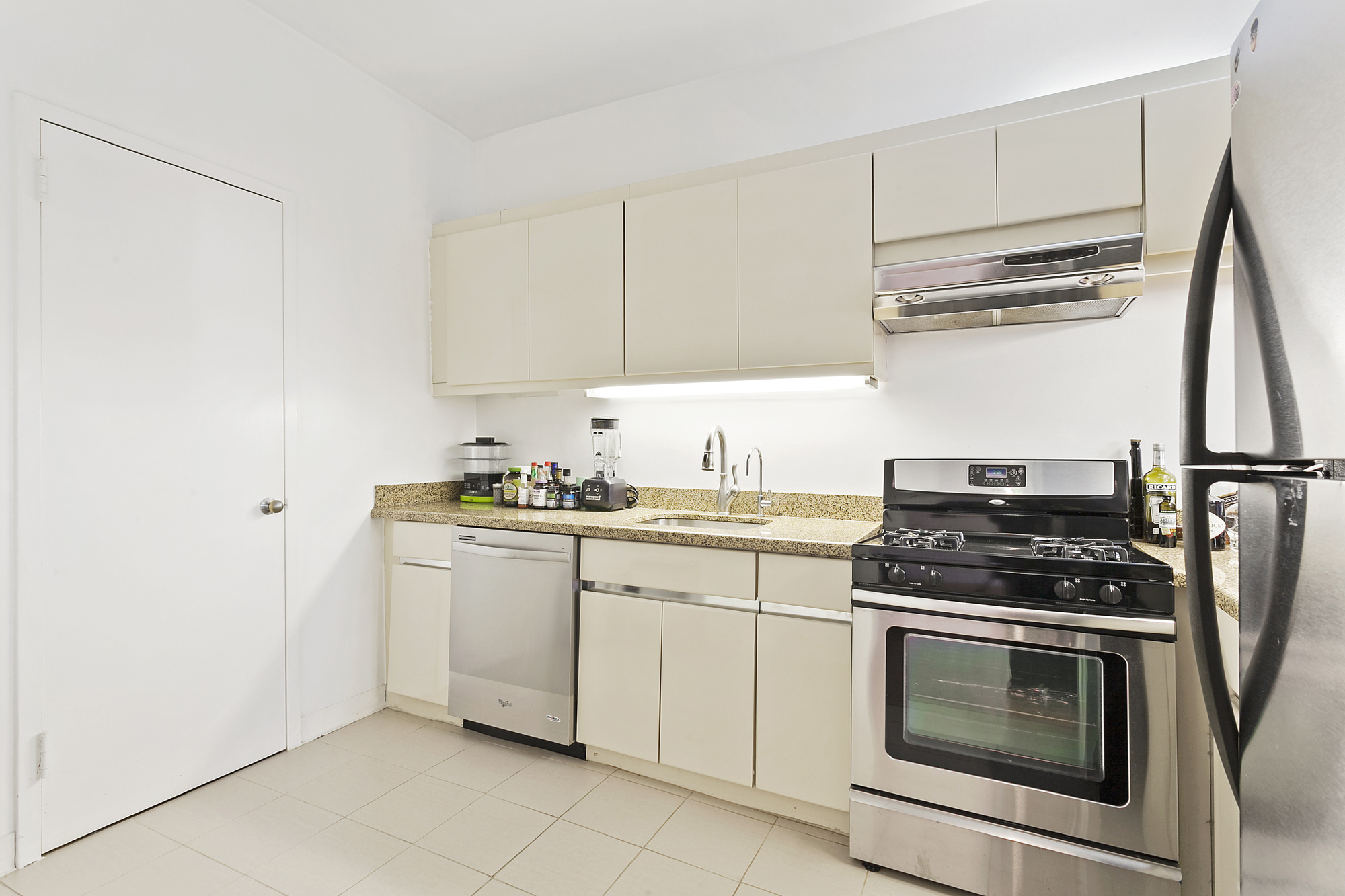 354 Broome Street, Unit 3E Manhattan, NY 10013 - Photo 4 of 5 a kitchen with cabinets appliances and a sink