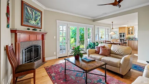 a living room with furniture fireplace and a large window