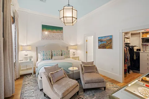 a living room with furniture and a chandelier