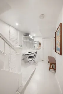 a workspace with furniture and white walls
