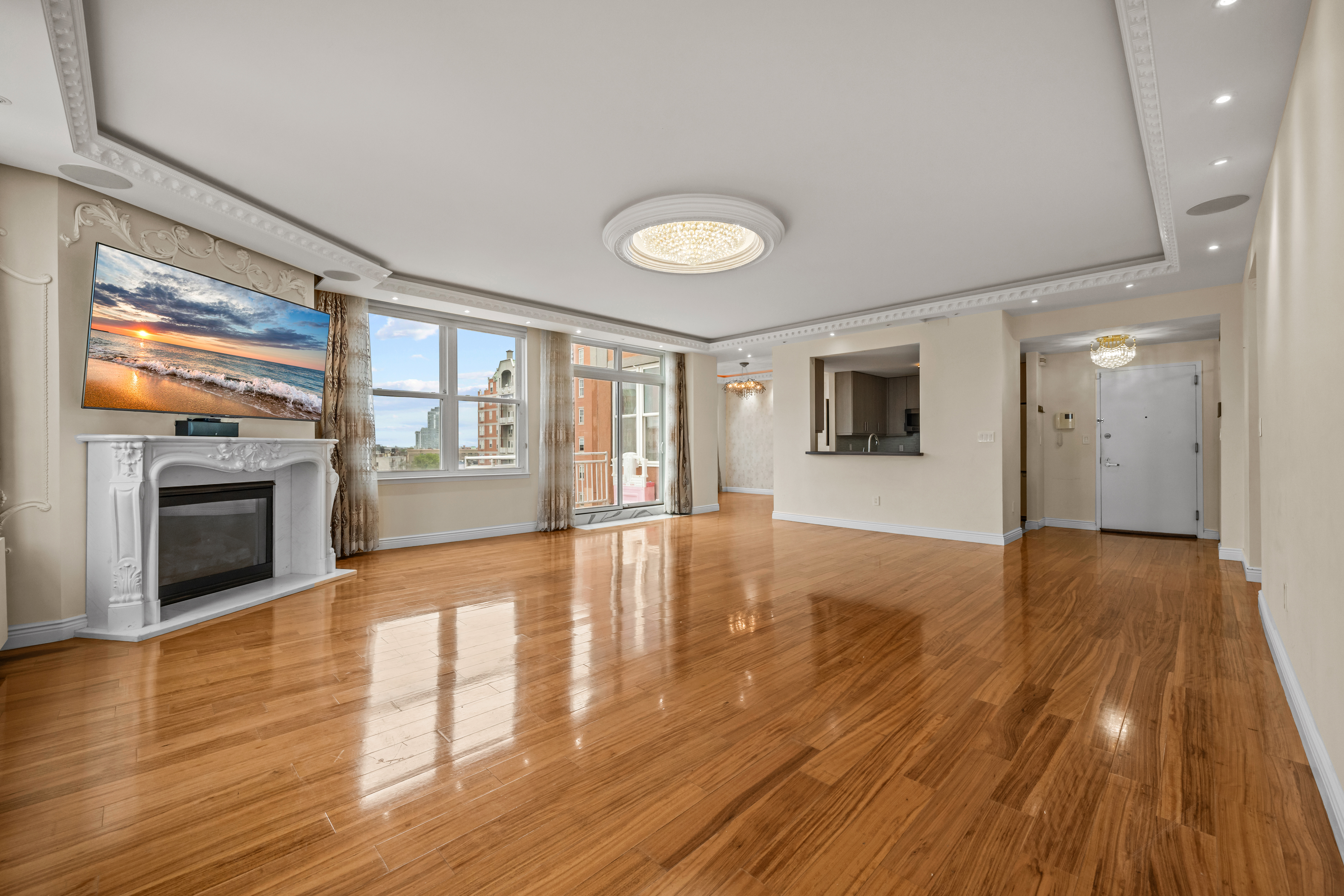 105 Oceana Drive East, Unit PH1D Brooklyn, NY 11235 - Photo 4 of 27 a view of an empty room with wooden floor and a fireplace