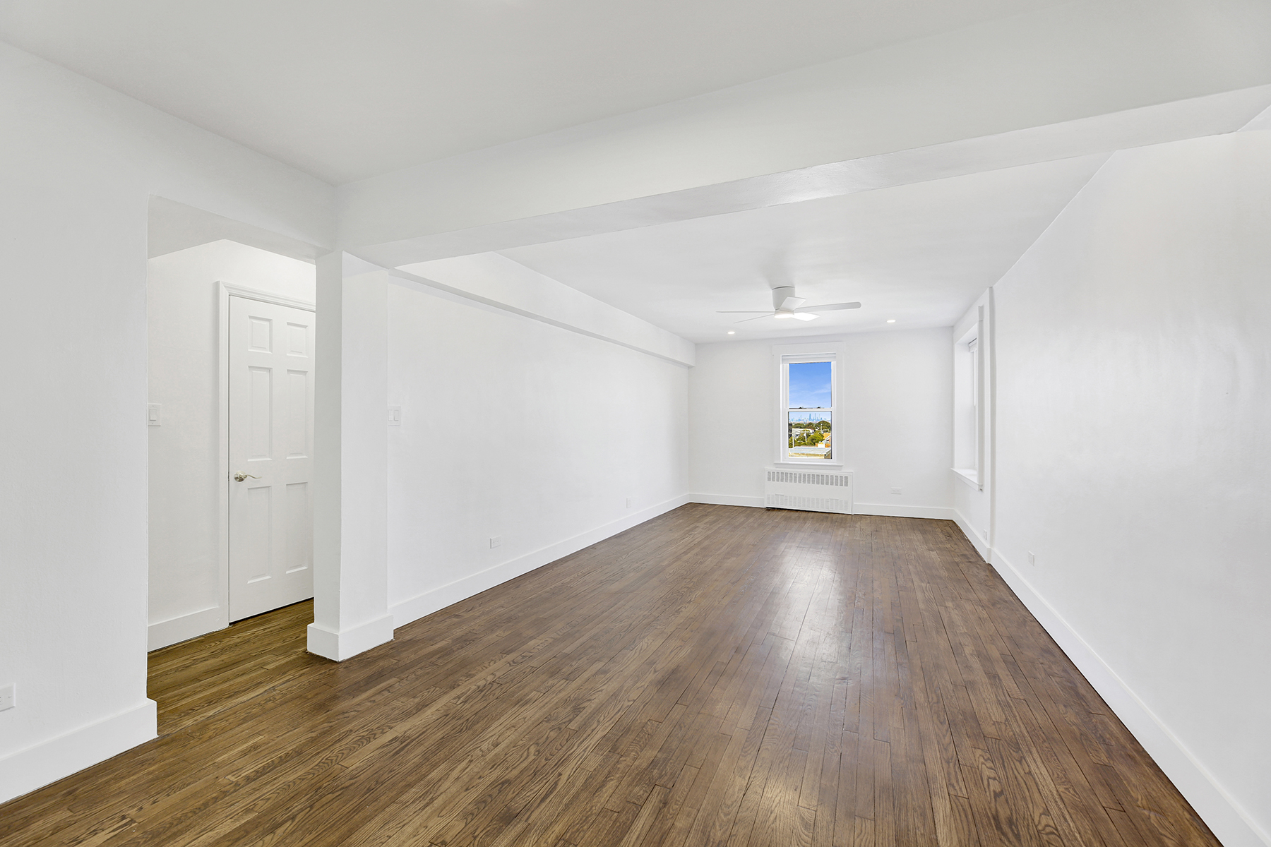 125 Beach 124th Street, Unit 5K Queens, NY 11694 - Photo 7 of 21 an empty room with wooden floor and windows