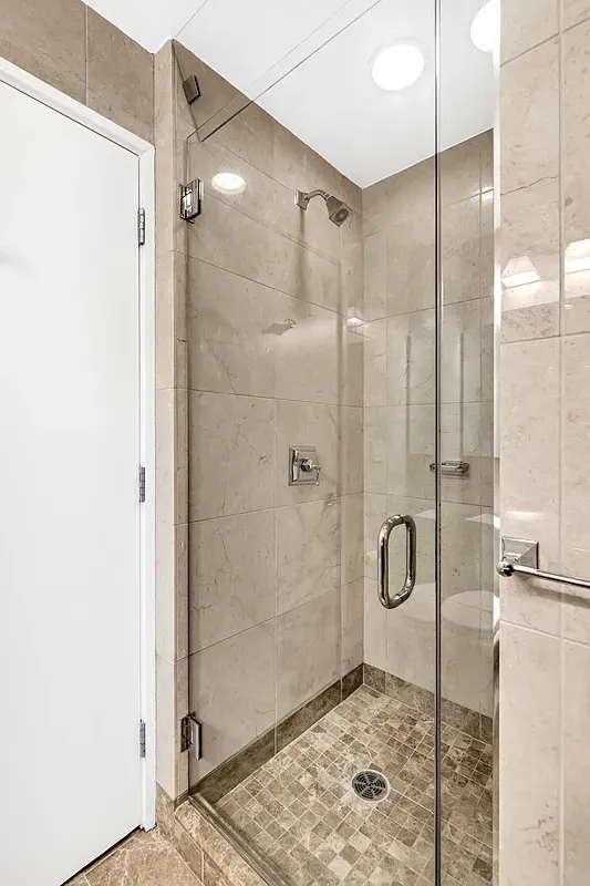 a bathroom with a shower and a sink