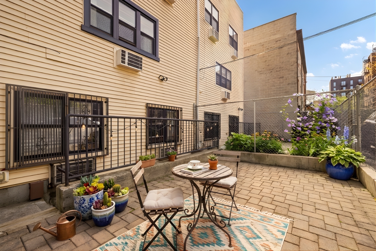 109 Pulaski Street Brooklyn, NY 11206 - Photo 12 of 14 a view of a patio with couple of chairs and potted plants