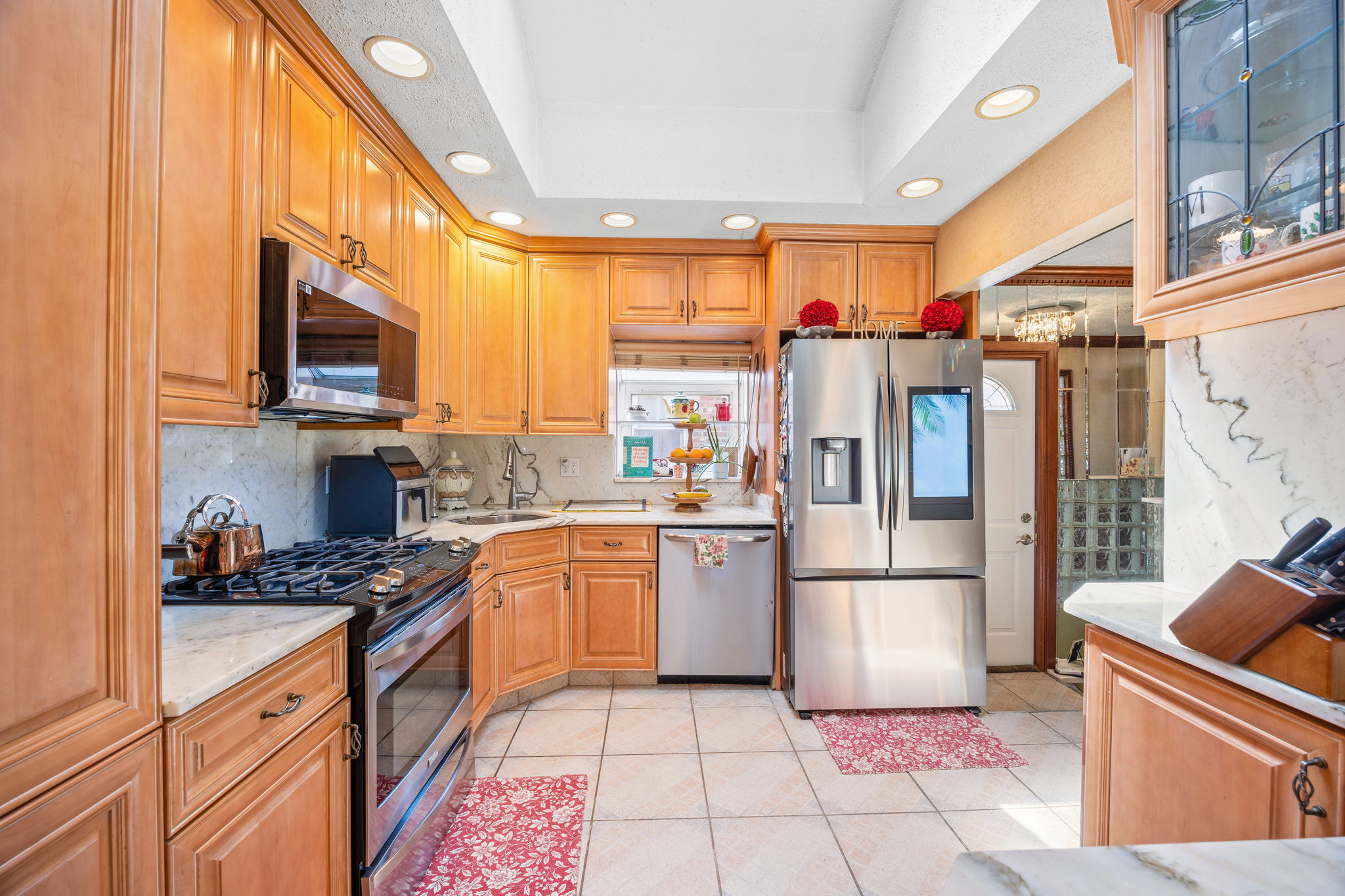 141-18 14th Avenue Queens, NY 11357 - Photo 9 of 26 a kitchen with stainless steel appliances granite countertop a refrigerator and a stove top oven