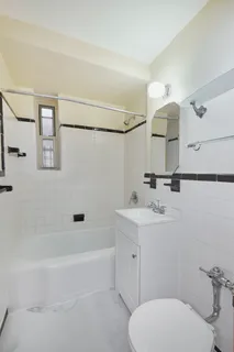 a bathroom with a toilet sink and mirror or bathtub