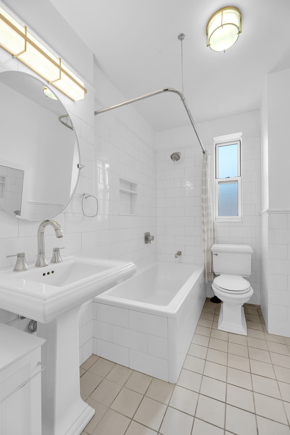 73-12 35th Avenue, Unit A62 Queens, NY 11372 - Photo 7 of 10 a bathroom with a sink a toilet and a bathtub