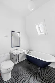 a bathroom with a toilet a sink and mirror