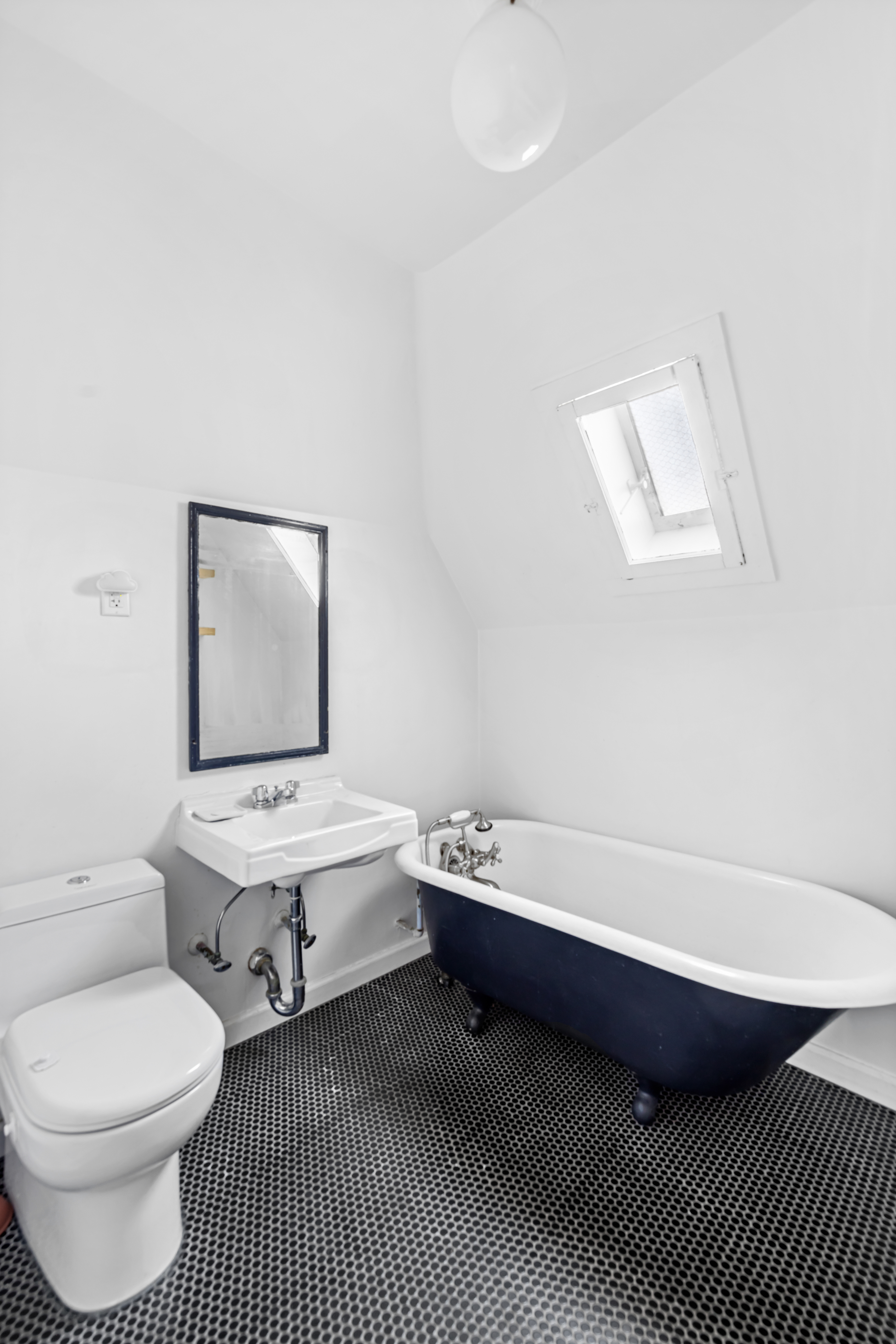 792 East 21st Street Brooklyn, NY 11210 - Photo 19 of 29 a bathroom with a toilet a sink and mirror
