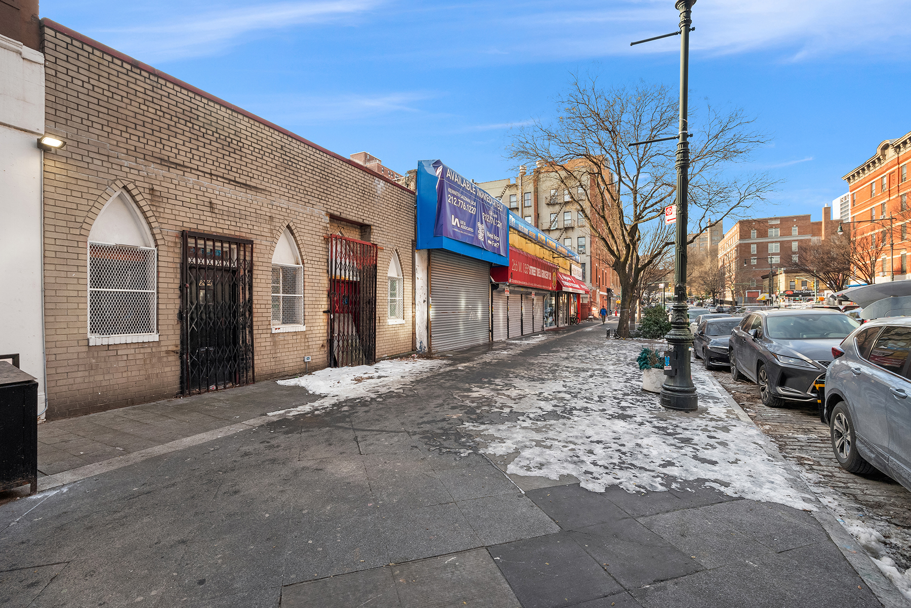 264 West 135th Street Manhattan, NY 10030 - Photo 3 of 4 a view of a building with car parked
