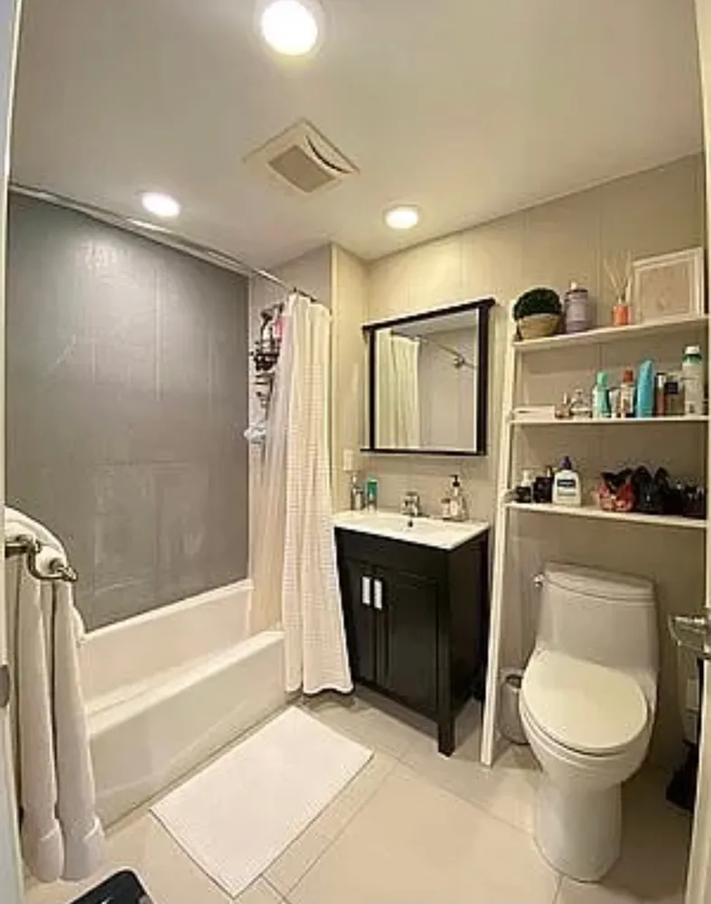 a spacious bathroom with a bathtub shower sink mirror and toilet
