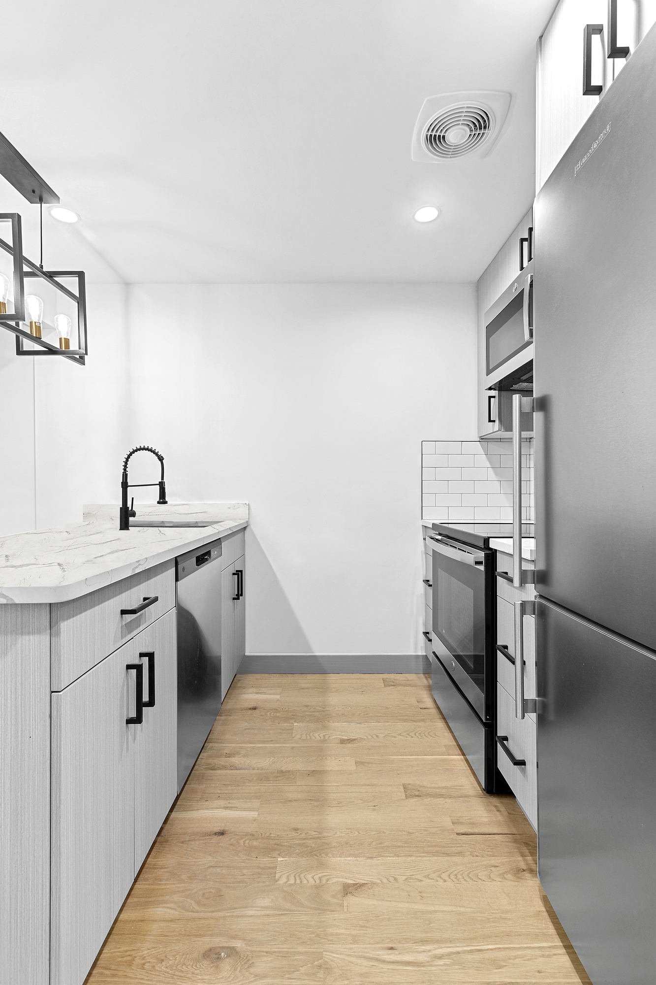 162 Cornelia Street, Unit 1 Brooklyn, NY 11221 - Photo 9 of 11 a kitchen with cabinets and stainless steel appliances