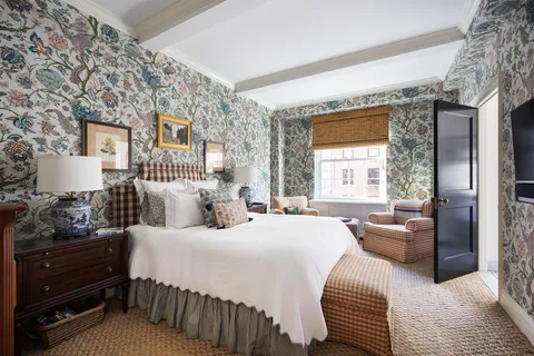 a bedroom with a bed a couch and dresser