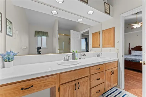 a bathroom with a sink double vanity granite and a mirror