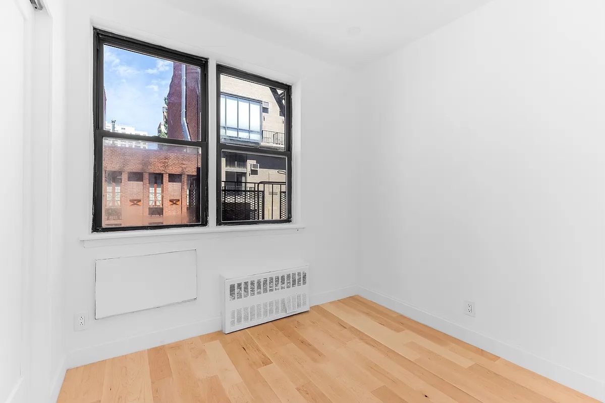 324 East 84th Street, Unit 1D Manhattan, NY 10028 - Photo 5 of 6 a view of a big room with wooden floor and windows