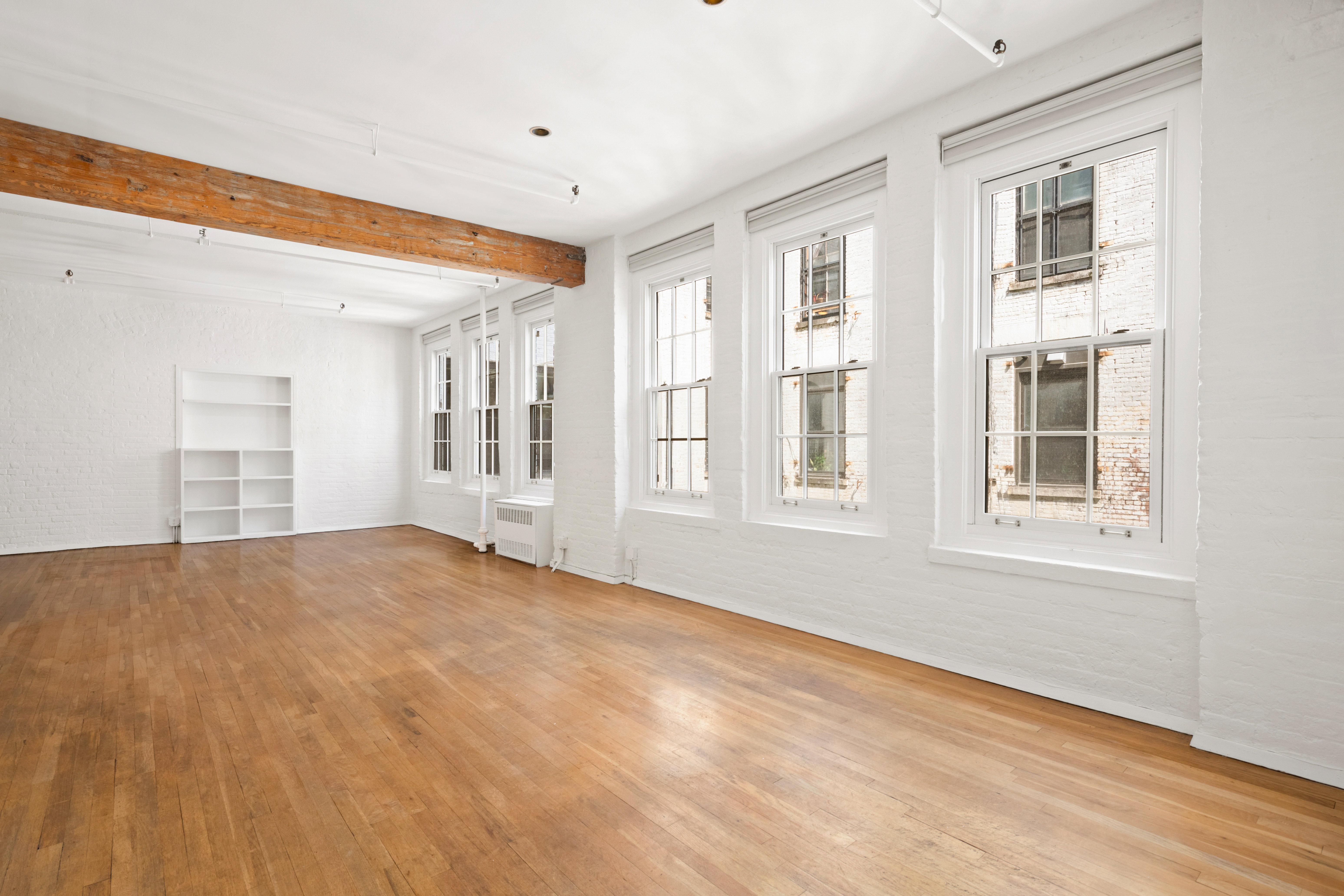 140 Thompson, Unit 4A Manhattan, NY 10012 - Photo 8 of 13 a view of an empty room with a window