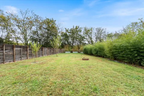 a view of a yard with a house in the background
