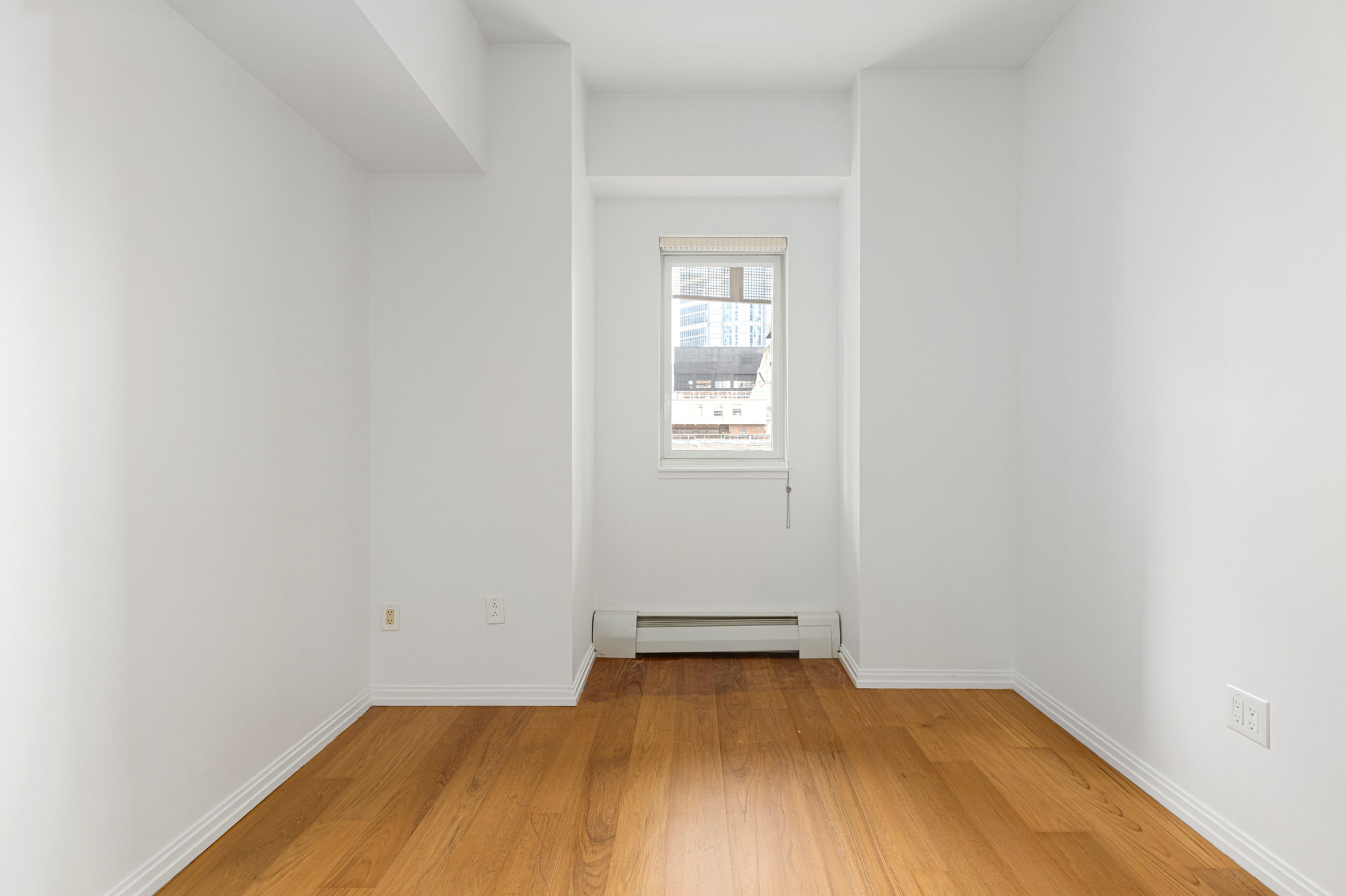 205 East 59th Street, Unit 10B Manhattan, NY 10022 - Photo 8 of 10 an empty room with a window