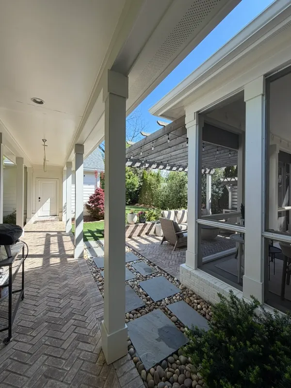 a view of a porch with chairs and backyard