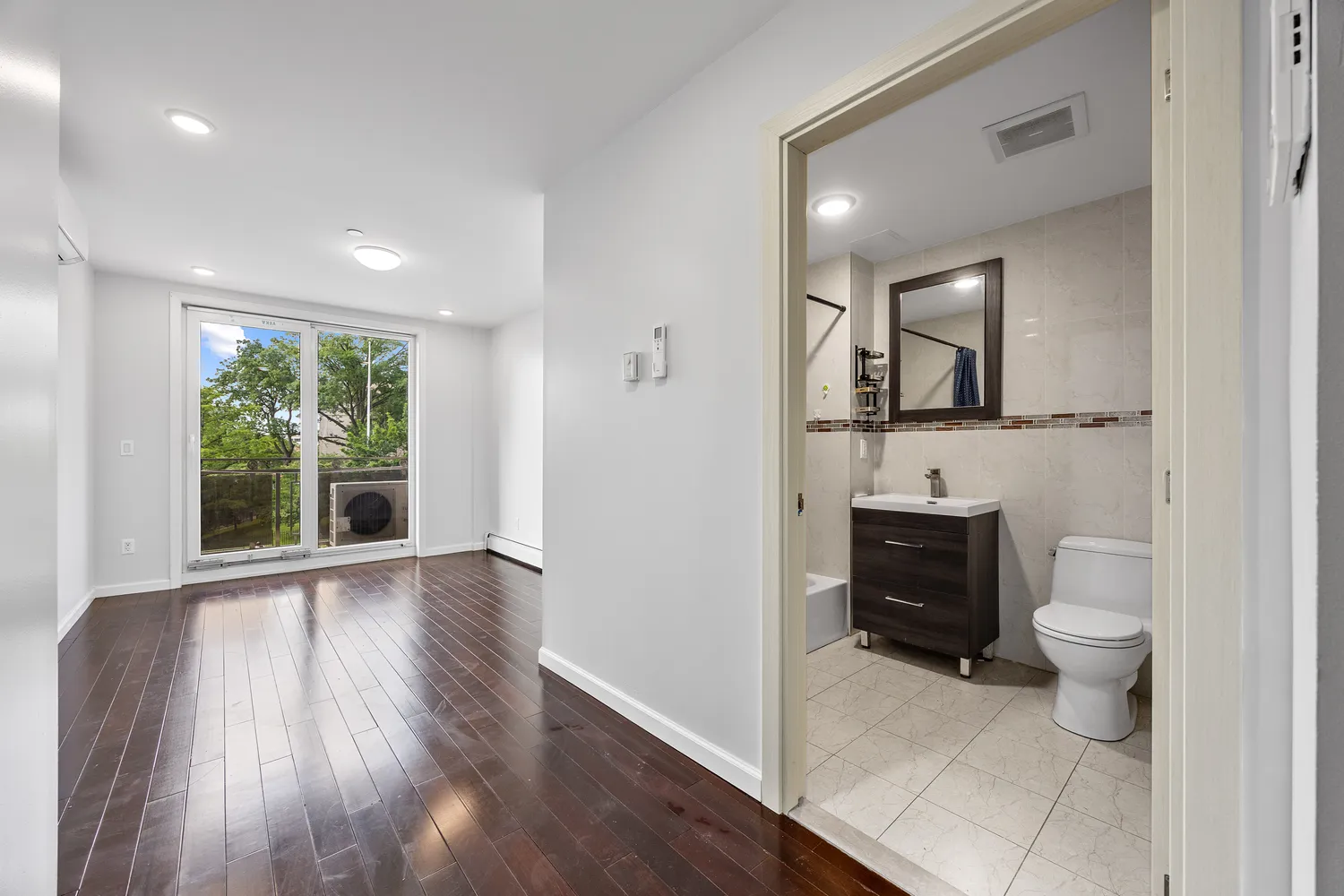 a spacious bathroom with a toilet sink and mirror