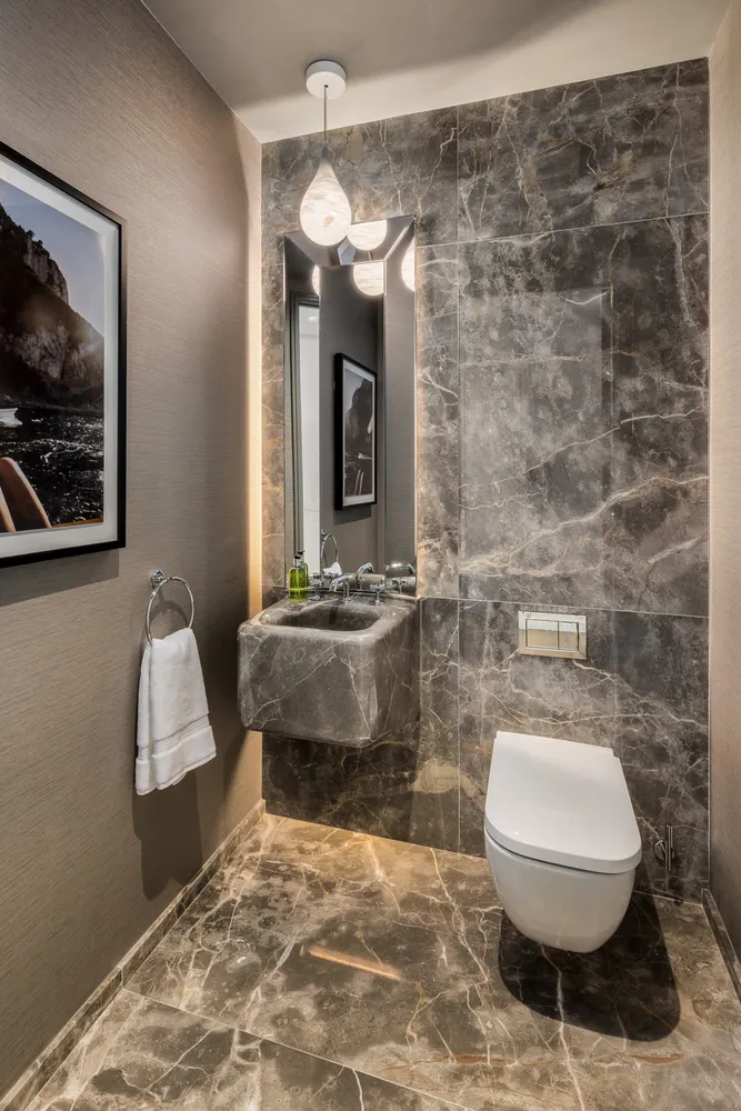 a bathroom with a toilet a sink and mirror