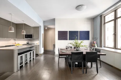 a view of a dining room with furniture and window