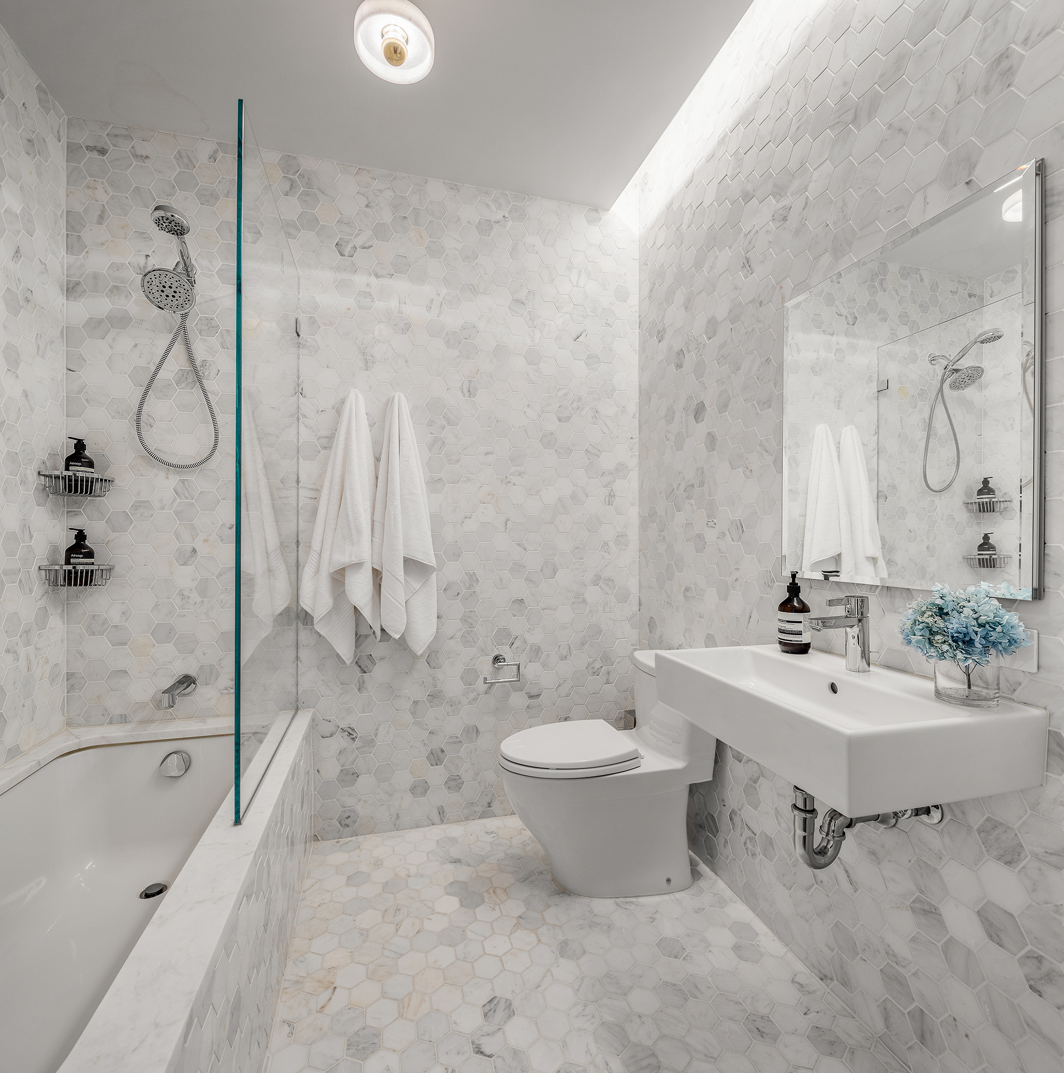 325 West Broadway, Unit 4B Manhattan, NY 10013 - Photo 11 of 17 a bathroom with a sink a toilet and shower