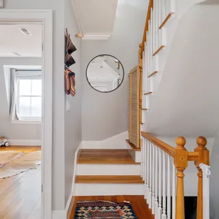 a view of a porch with wooden floor and a window