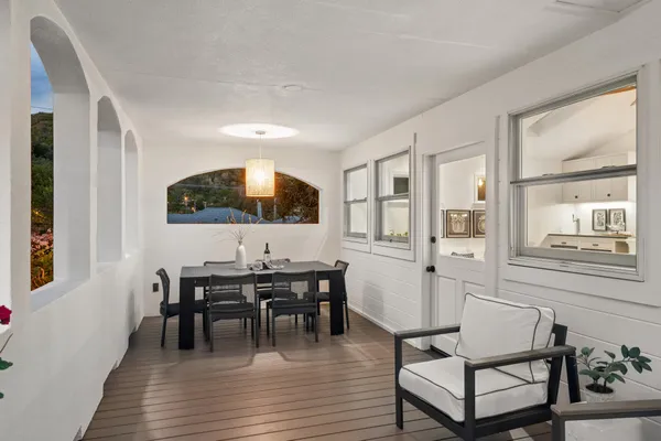 a view of a dining room with furniture and wooden floor
