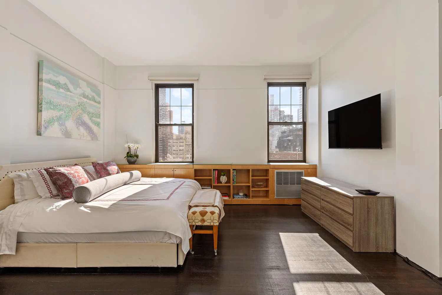 a bedroom with a bed and a flat screen tv