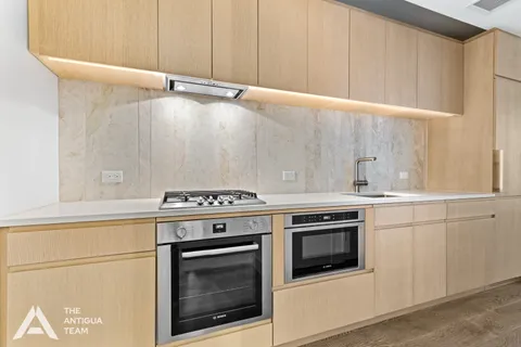 a stove top oven sitting inside of a kitchen