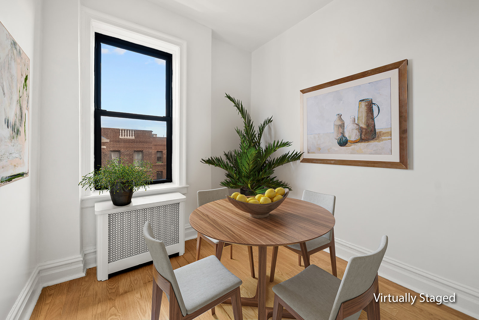 83-10 35th Avenue, Unit 6C Queens, NY 11372 - Photo 7 of 13 a living room with furniture and a potted plant