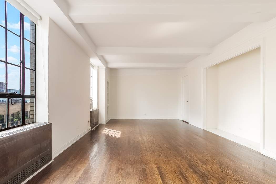 340 West 57th Street, Unit 14E Manhattan, NY 10019 - Photo 7 of 13 a view of an empty room with wooden floor and a window