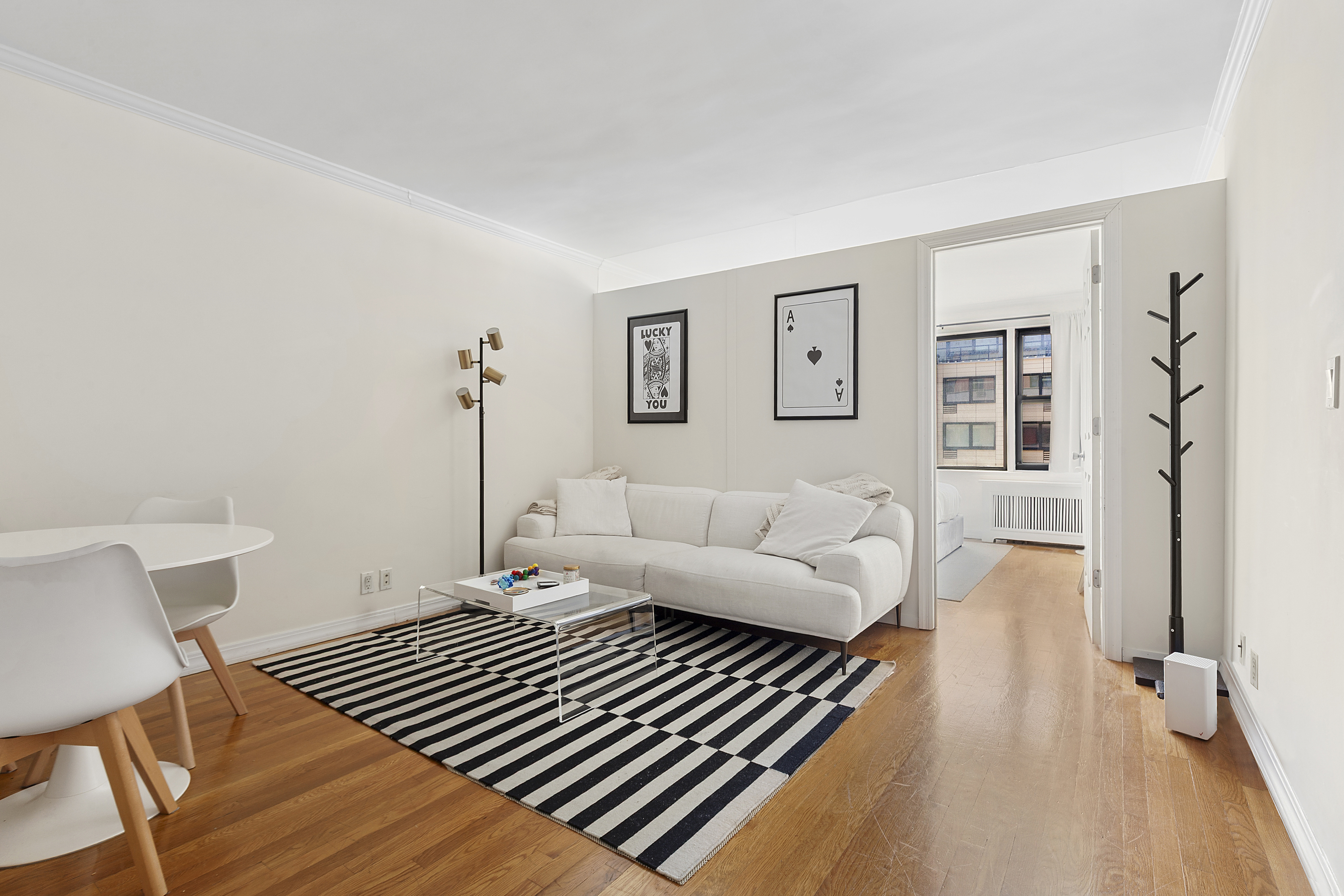 333 East 34th Street, Unit 14J Manhattan, NY 10016 - Photo 1 of 10 a bedroom with a bed and wooden floor