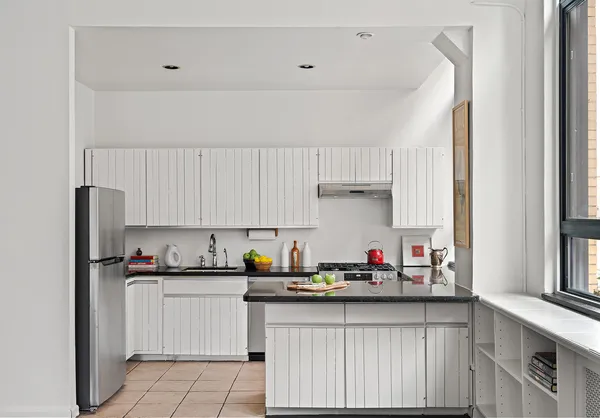 a kitchen with stainless steel appliances granite countertop a refrigerator sink and cabinets