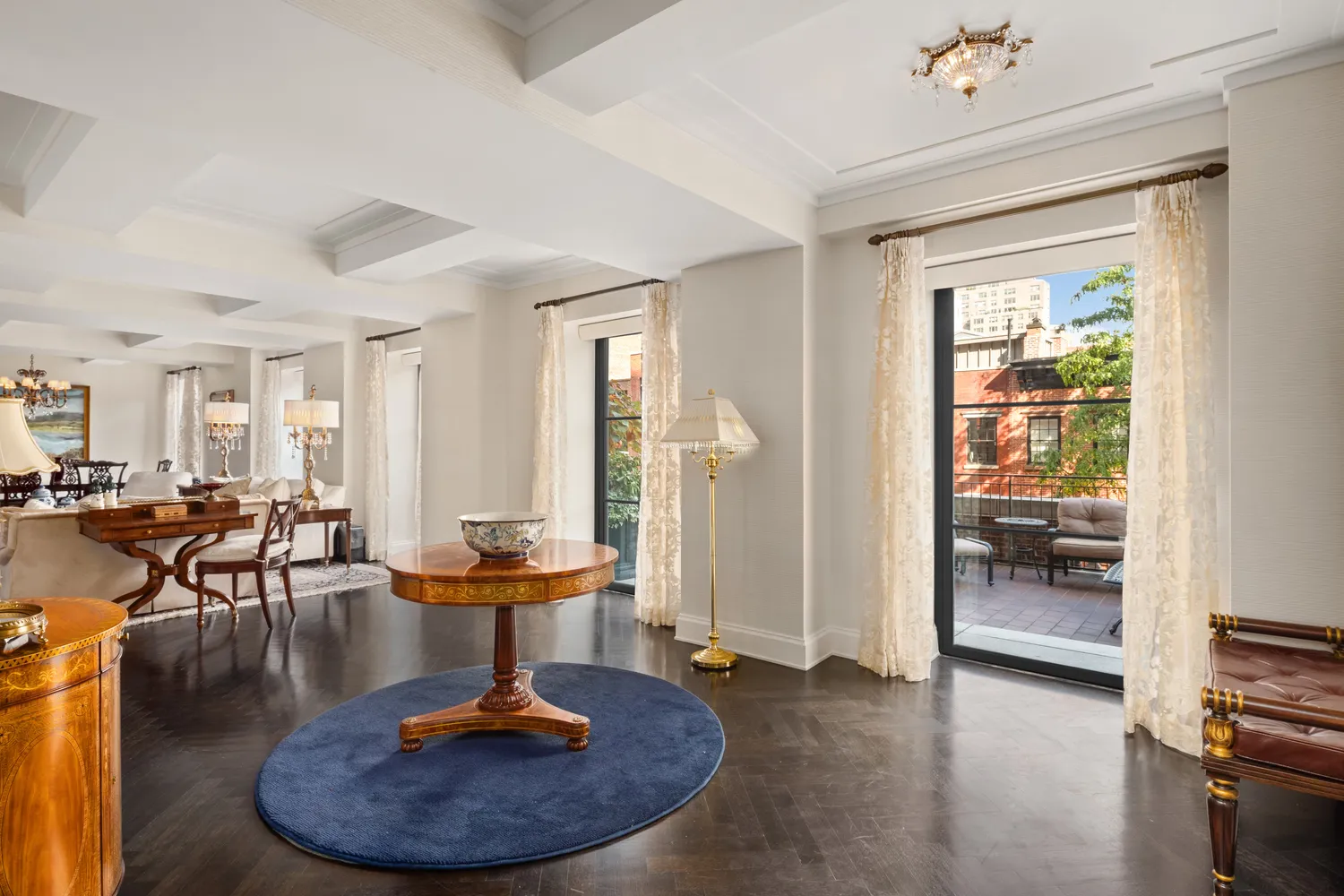 a living room with furniture and a chandelier