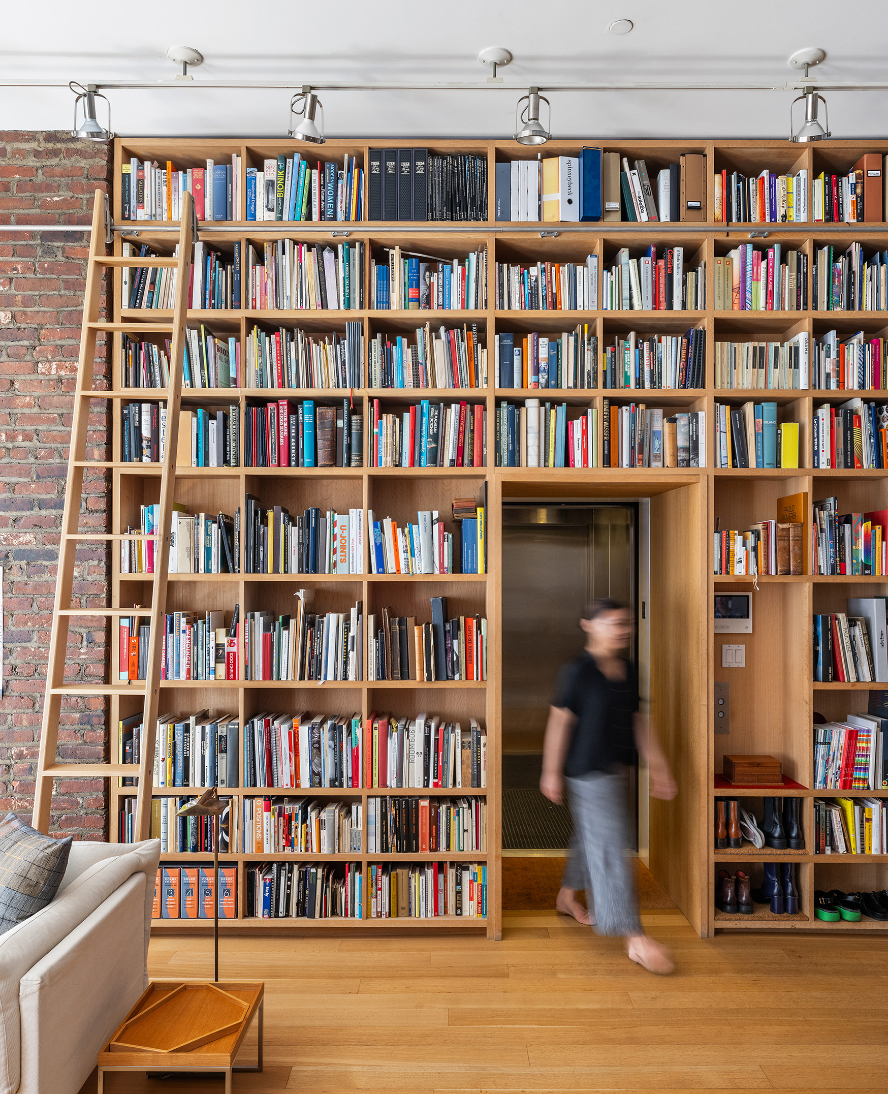 71 Ludlow Street, Unit 4B Manhattan, NY 10002 - Photo 4 of 15 a living room with furniture and a book shelf