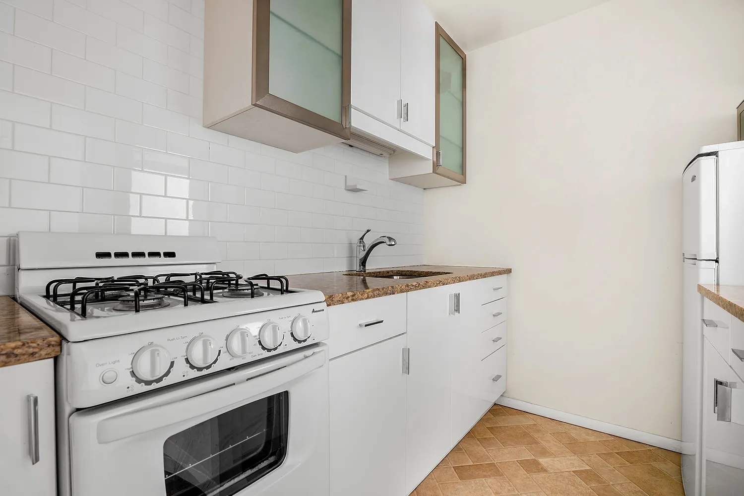 a white stove top oven sitting inside of a kitchen