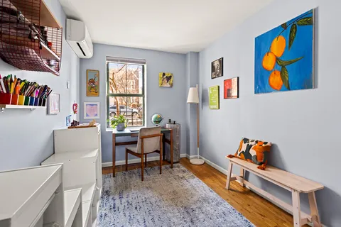 a reading room with furniture rug and window